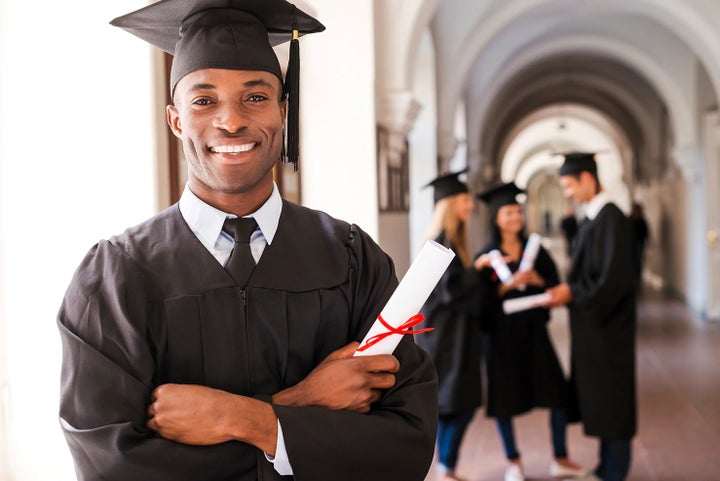 college graduate holding his diploma | Dalton Subaru National City in National City CA