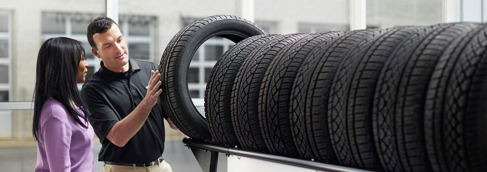 Subaru service representative showing customer a tire. | Dalton Subaru National City in National City CA
