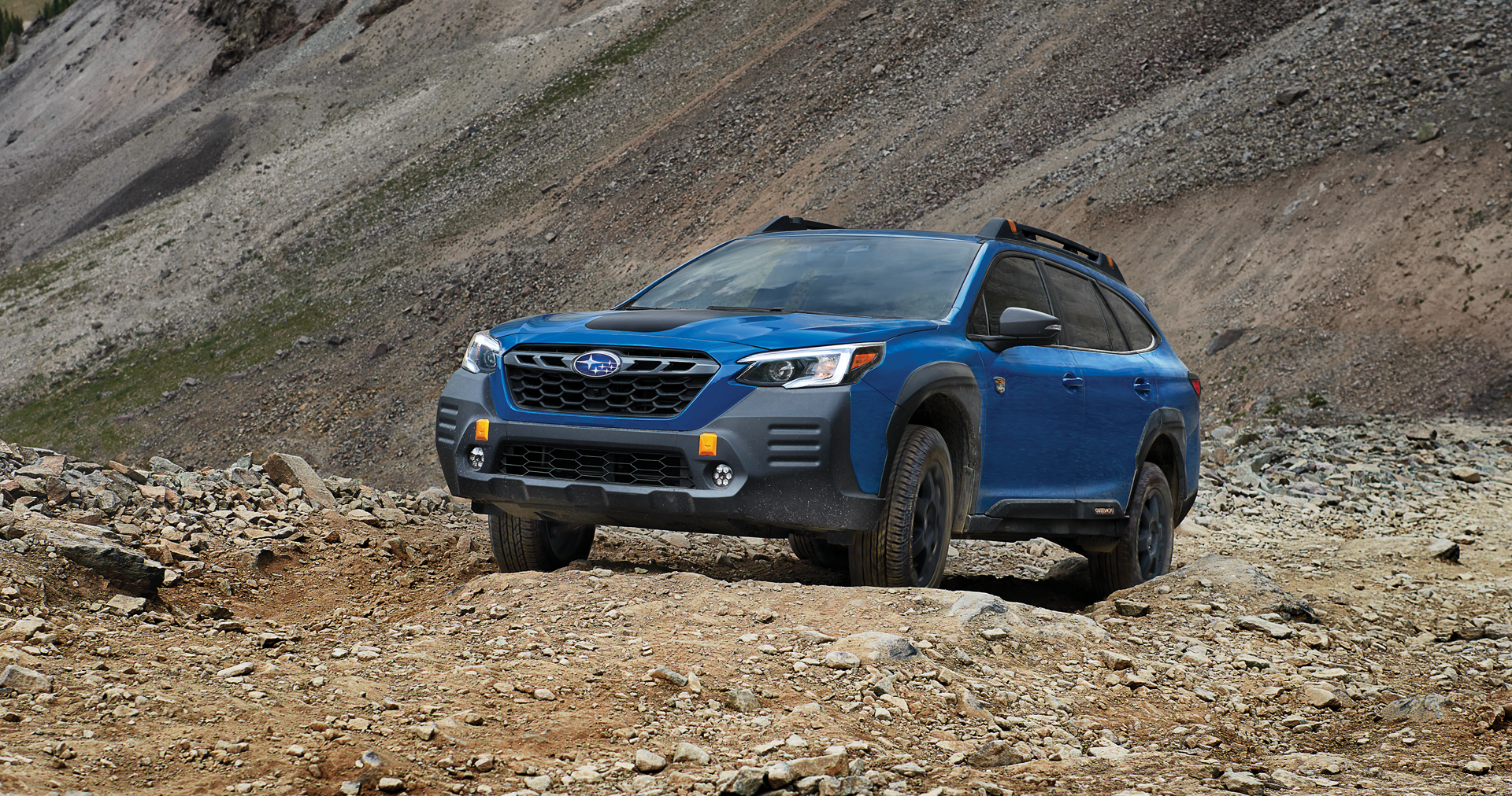A 2023 Outback Wilderness driving on a trail in the mountains. | Dalton Subaru in National City CA