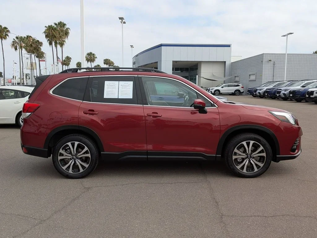 Side profile of the red used 2024 Subaru Forester Limited, showing alloy wheels and roof rails, at Dalton Subaru National City