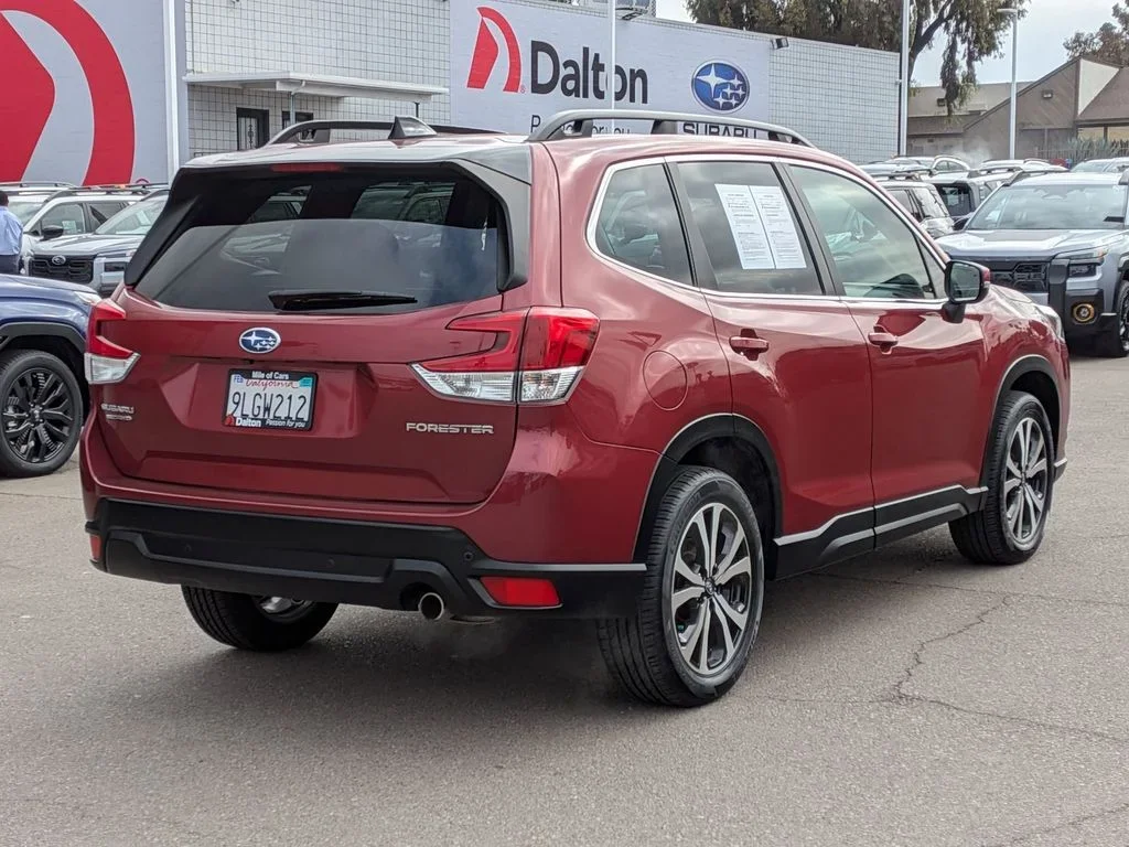 Rear three-quarter view of the red used 2024 Subaru Forester Limited in front of the Dalton Subaru building