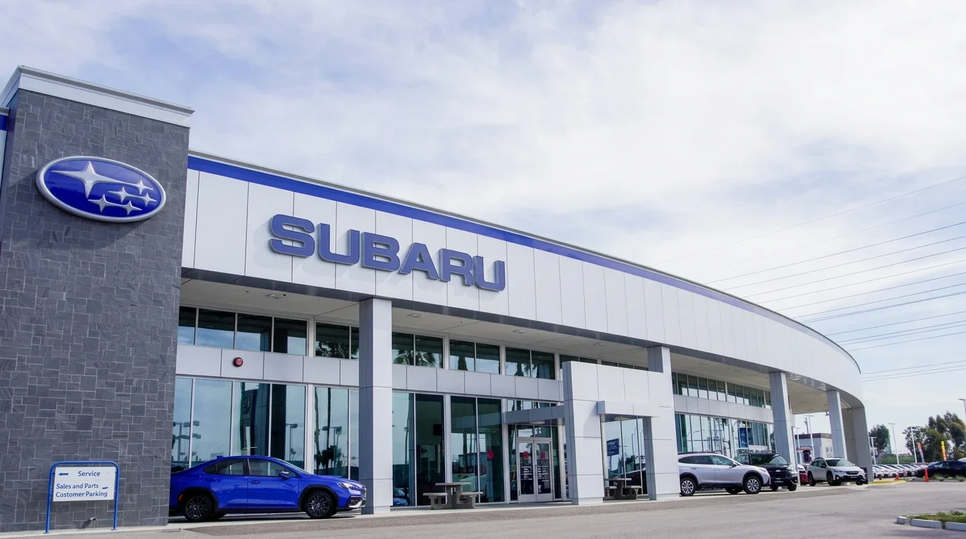 The Dalton Subaru National City storefront, with a blue WRX parked by the entrance and the lot beyond.