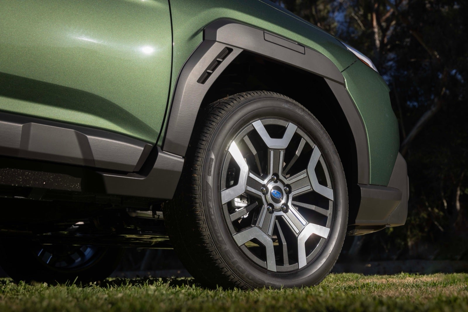 Close-up of a 2026 Outback front wheel and dark fender cladding.