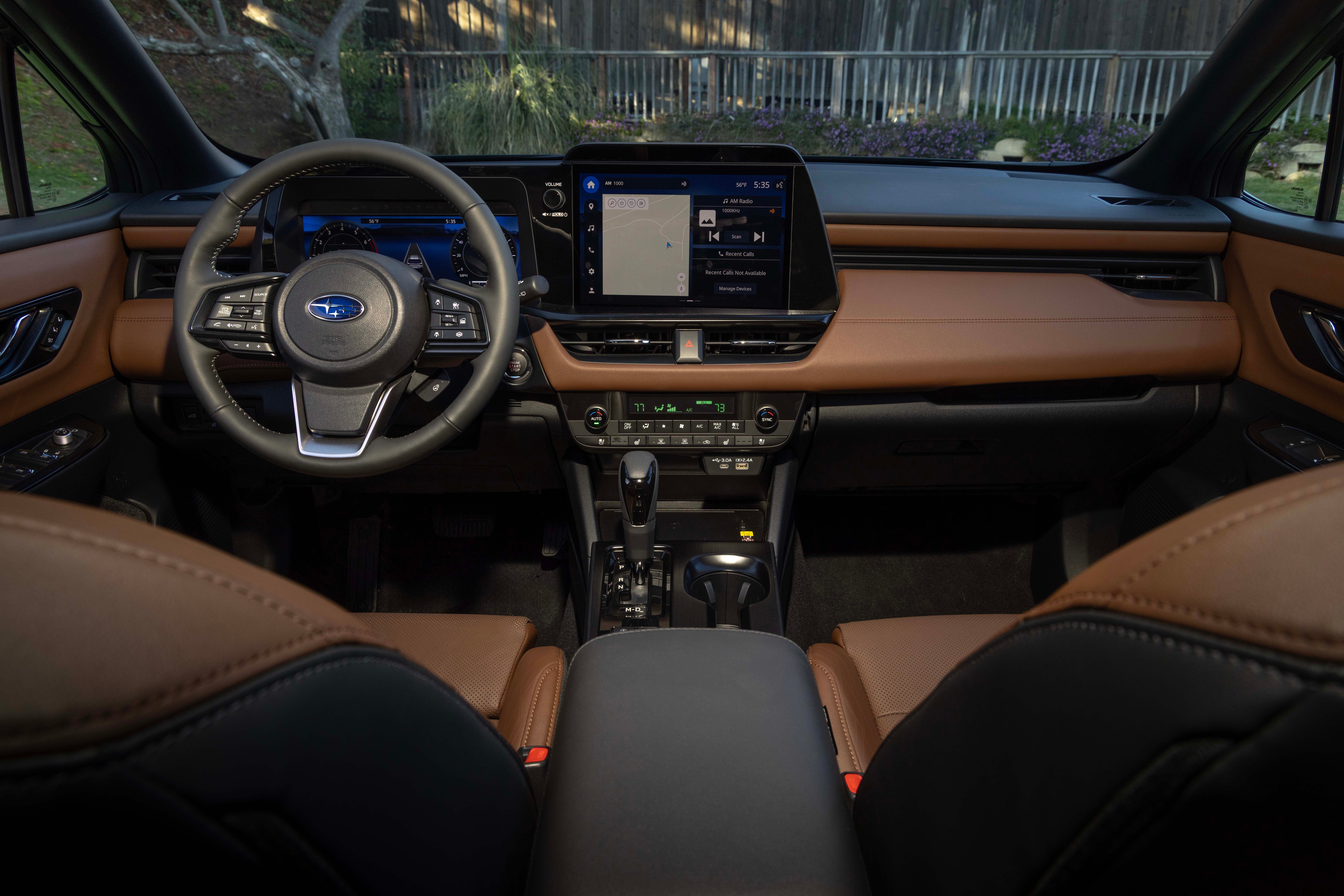 The Subaru Outback dashboard seen head-on, with the center touchscreen and tan leather seats either side