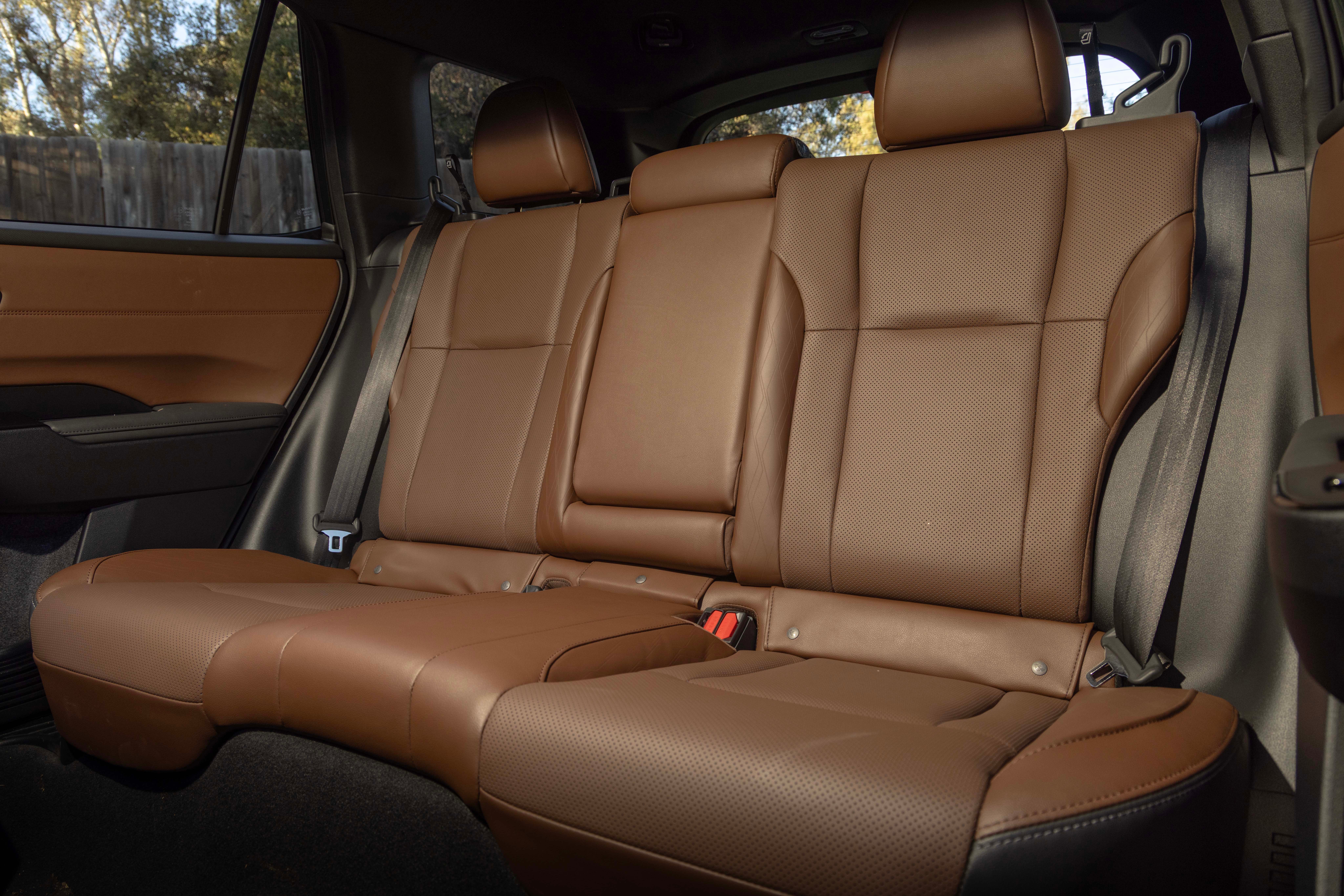 The second-row bench seat of a Subaru Outback in perforated tan leather